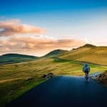 rear view of man on mountain road against sky