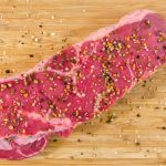 raw meat on beige wooden surface